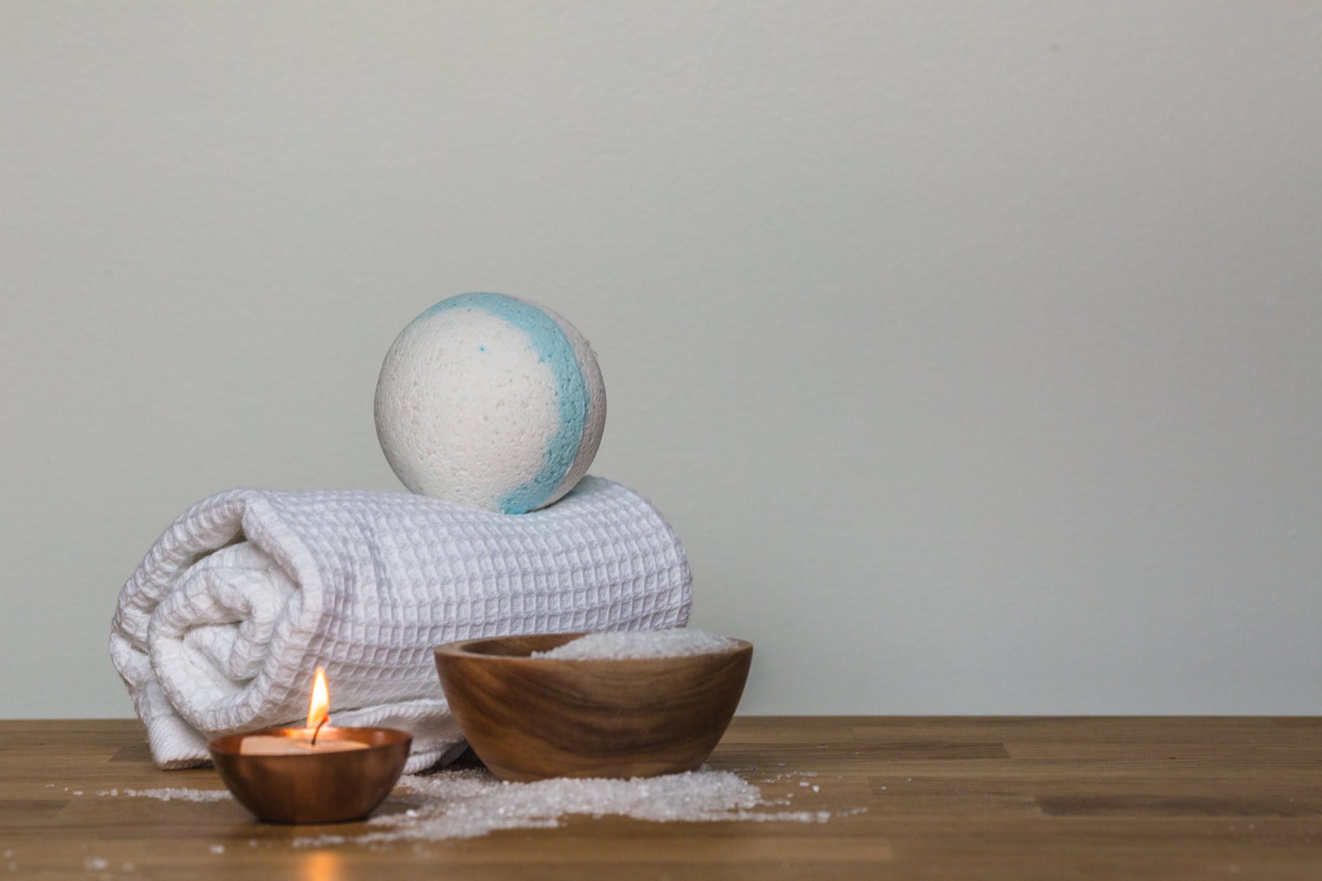 photo of towel and bath bomb near candle